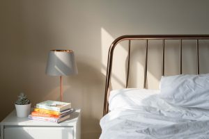 A rose gold metallic bedside table lamp